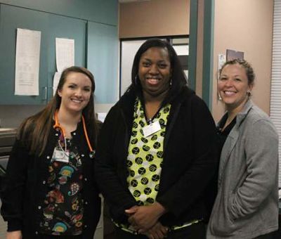 Picture of three ER staff female staff members standing in an office within the hospital.